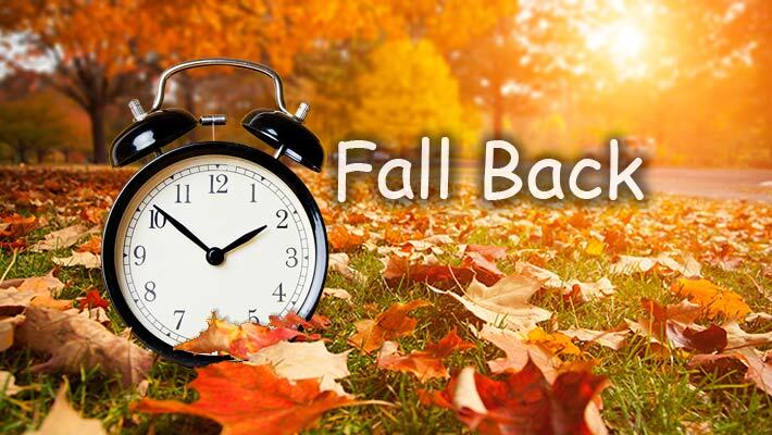 Fall Back with a clock and leaves in the background.