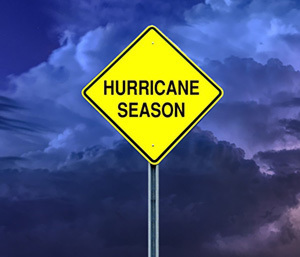 Hurricane Season on a sign with dark clouds in the background.