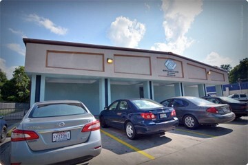 A row of cars in front of the Boys and Girls club.